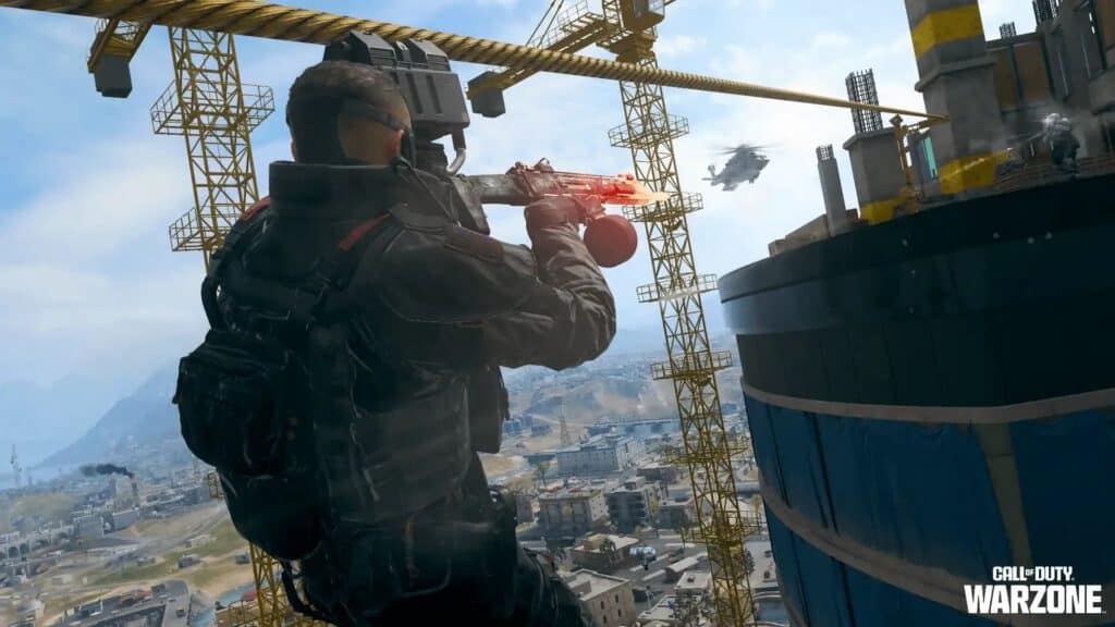 A player firing a weapon at a helicopter from a construction crane in Warzone