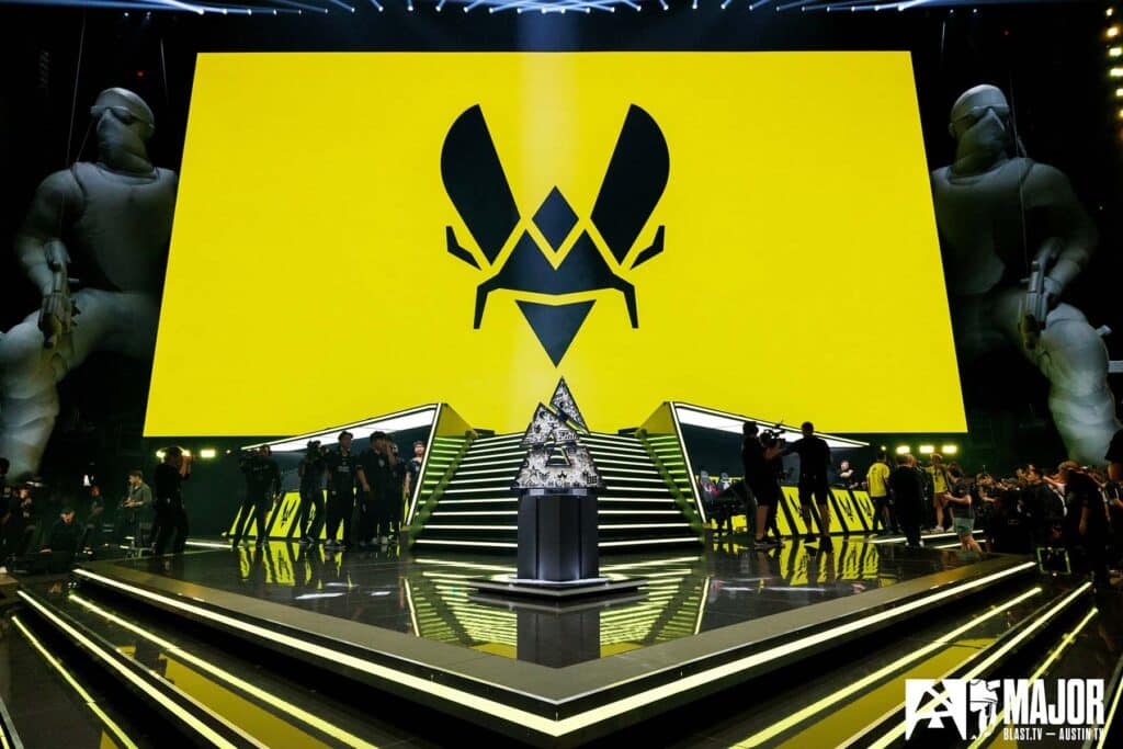 Image of Team Vitality logo on screen above BLAST Austin Major 2025 stage. The Austin Major trophy is in the centre of a stage on a platform