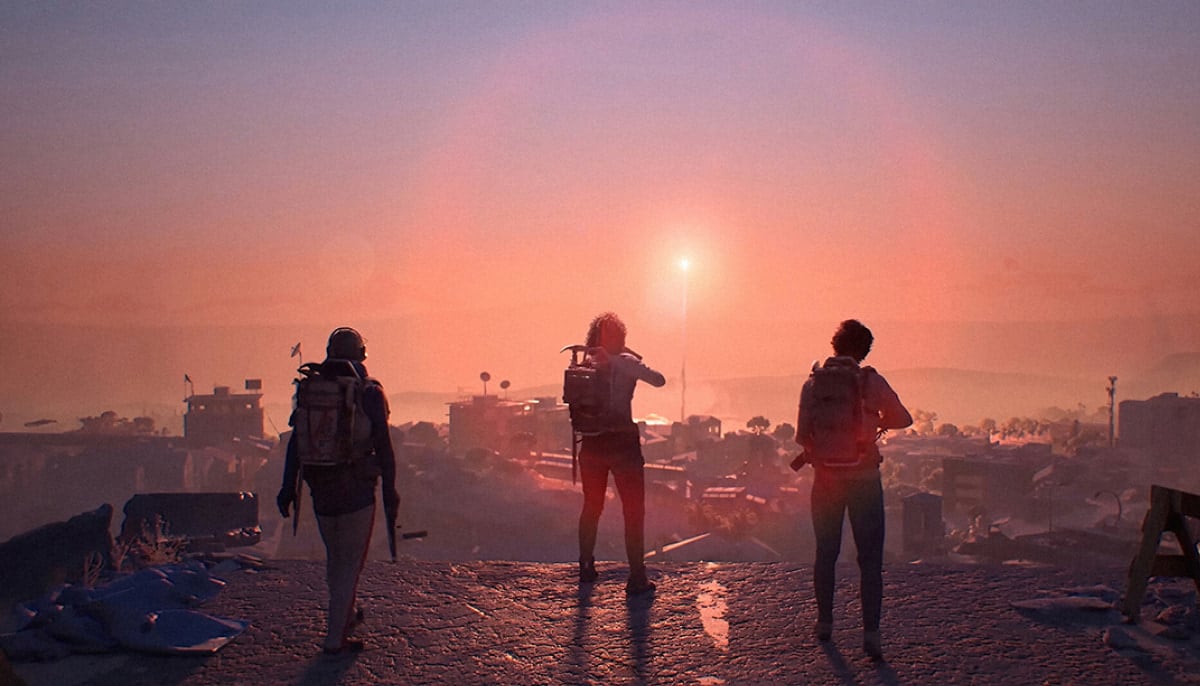 The image displays three armed characters standing with their backs to the viewer, looking out over a post-apocalyptic cityscape during sunset or sunrise in Arc Raiders