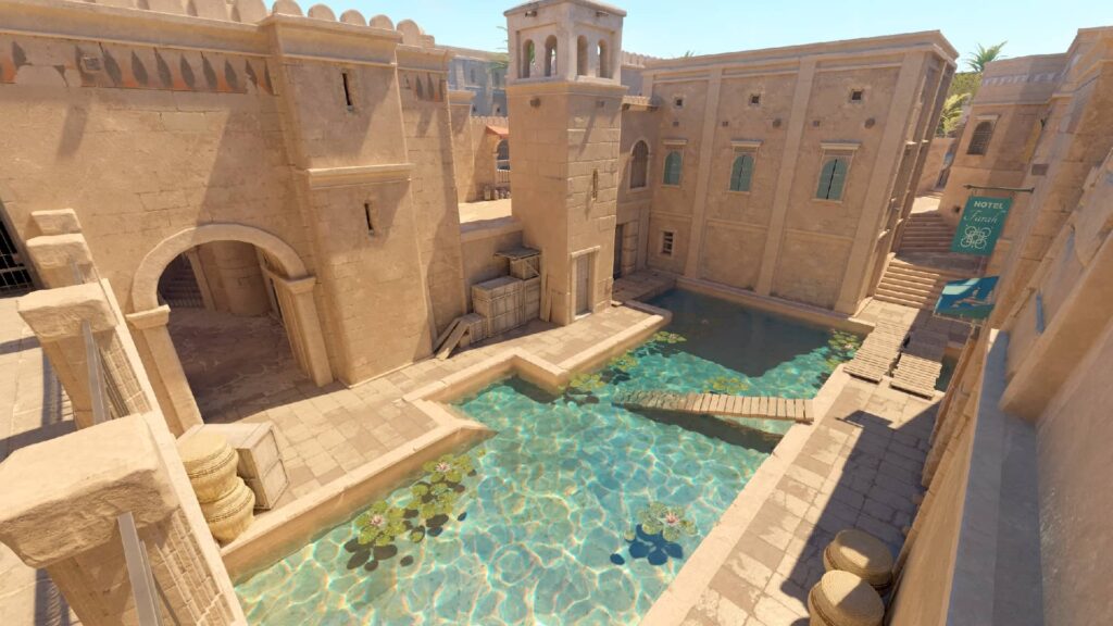 An environmental screenshot of the 'Water' or 'Canal' area on the Anubis map in the video game Counter-Strike 2, featuring Middle Eastern-themed architecture, a pool of water with lily pads, wooden bridges, and a sign for "Hotel"