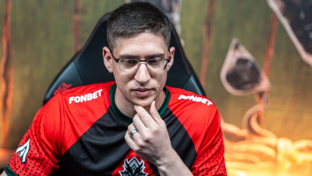 Tal Aizik wearing a headset and his team's red and black jersey featuring the Fonbet sponsor logo while focused on a screen during a PGL tournament match