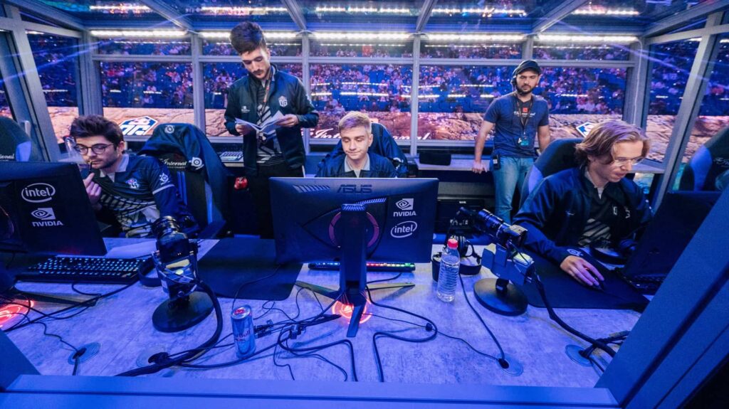 The image shows the famous Dota 2 team OG during their performance at a major tournament