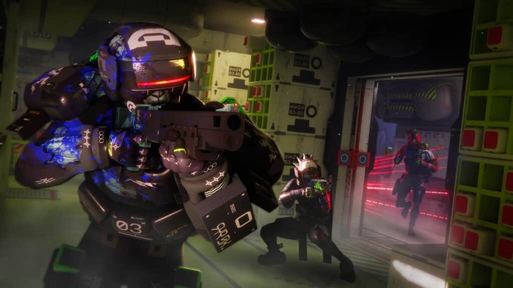 A screenshot from the game Marathon showing a character in dark, futuristic armor with a red visor and a green glow, aiming a pistol in a cramped, industrial hallway full of stacked crates. Two other characters are visible in the background through a doorway with a red-lit corridor beyond