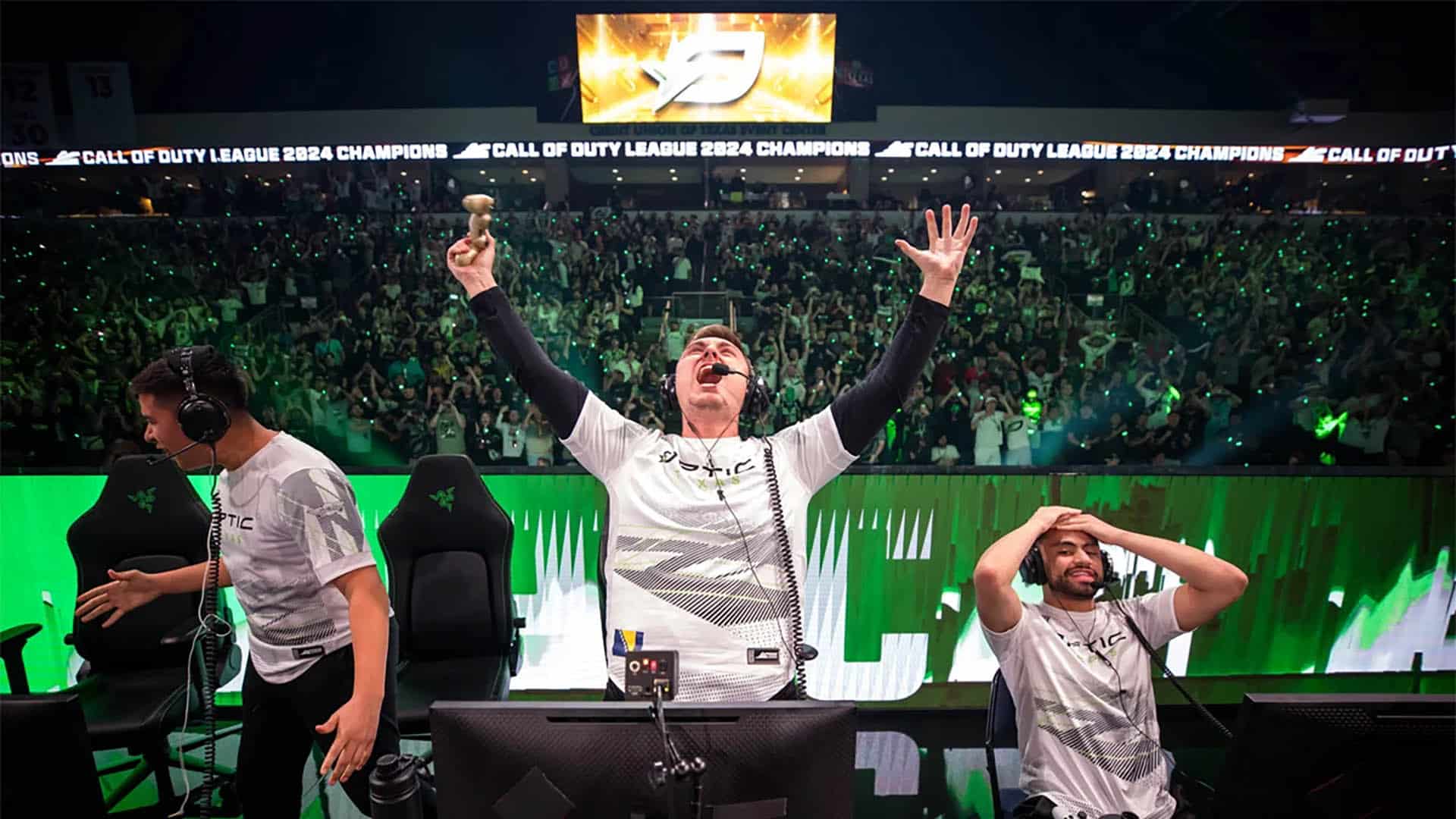 Image of OpTic Texas celebrating victory on stage at CDL Championship. Pred is screaming into the air with hands raised
