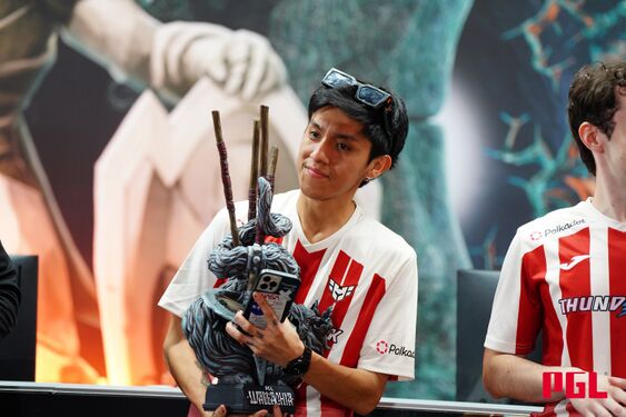 David 'Parker' Nicho lifting the Dota 2 trophy on stage.