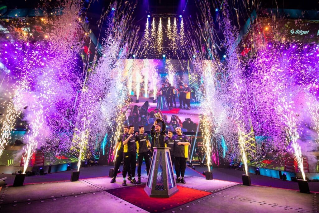 Image shows the Natus Vincere (NAVI) esports team celebrating their victory on stage with the trophy and confetti at the PGL Major Stockholm 2021.