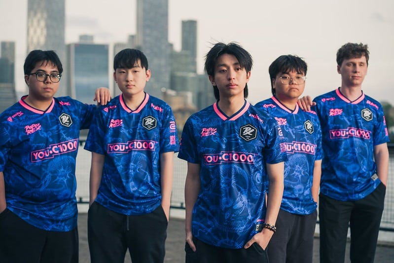 Picture of the professional esports team Paper Rex posing in their blue and pink team jerseys.